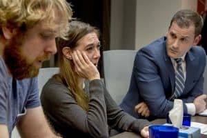Tom Minix and Kait Dowling crying, and their attorney, Jordan Strokovsky (right)
